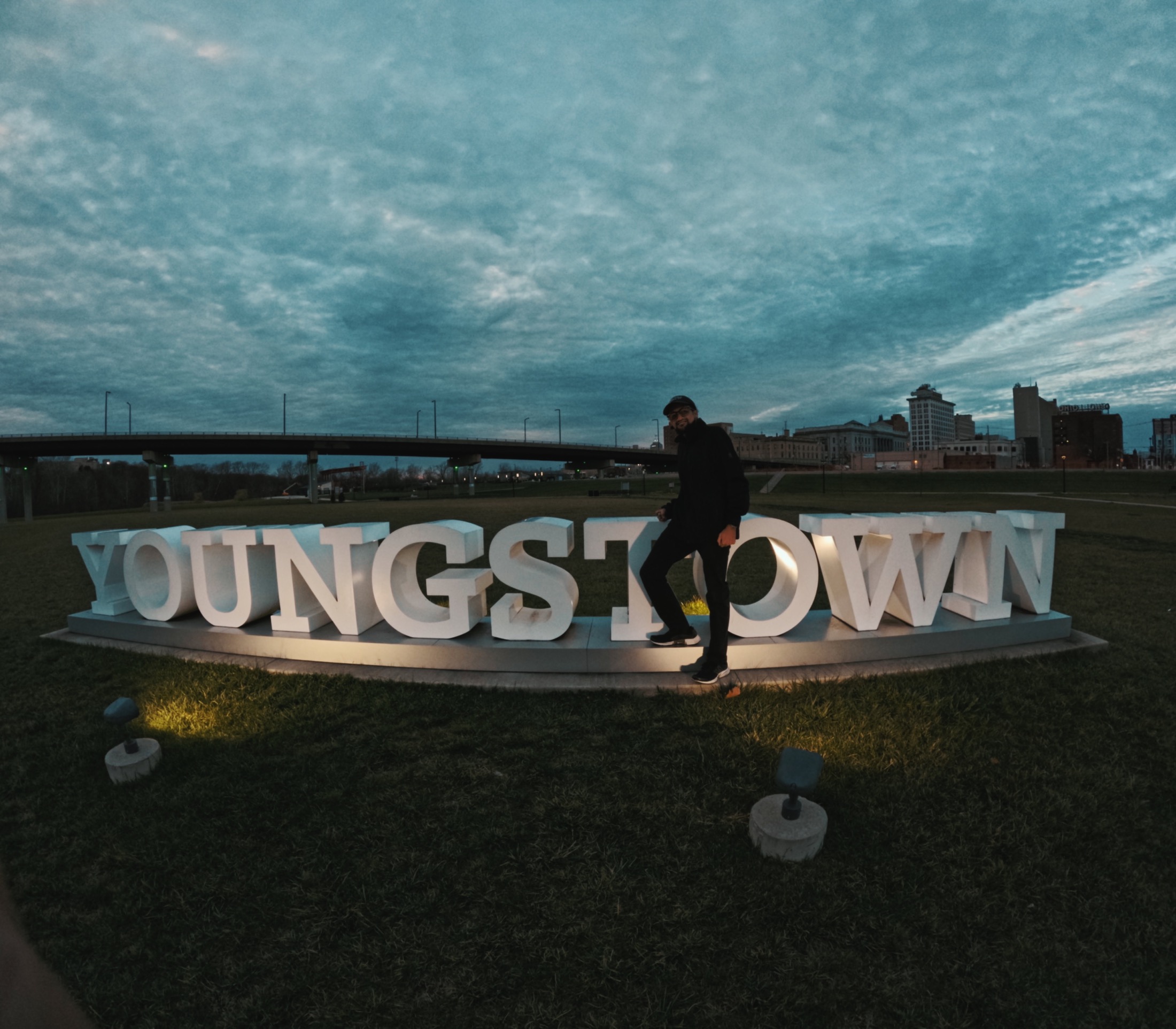 Manuel standing at the Youngstown sign